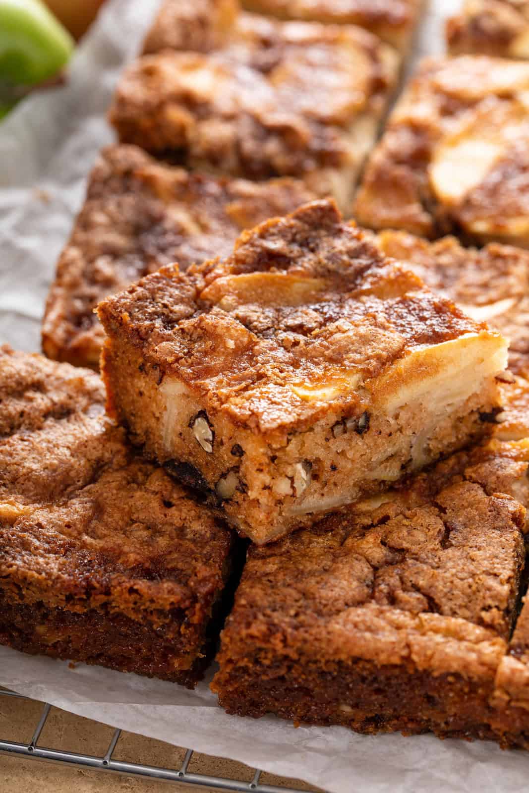 Slice of fresh apple cake stacked on other slices of the cake.