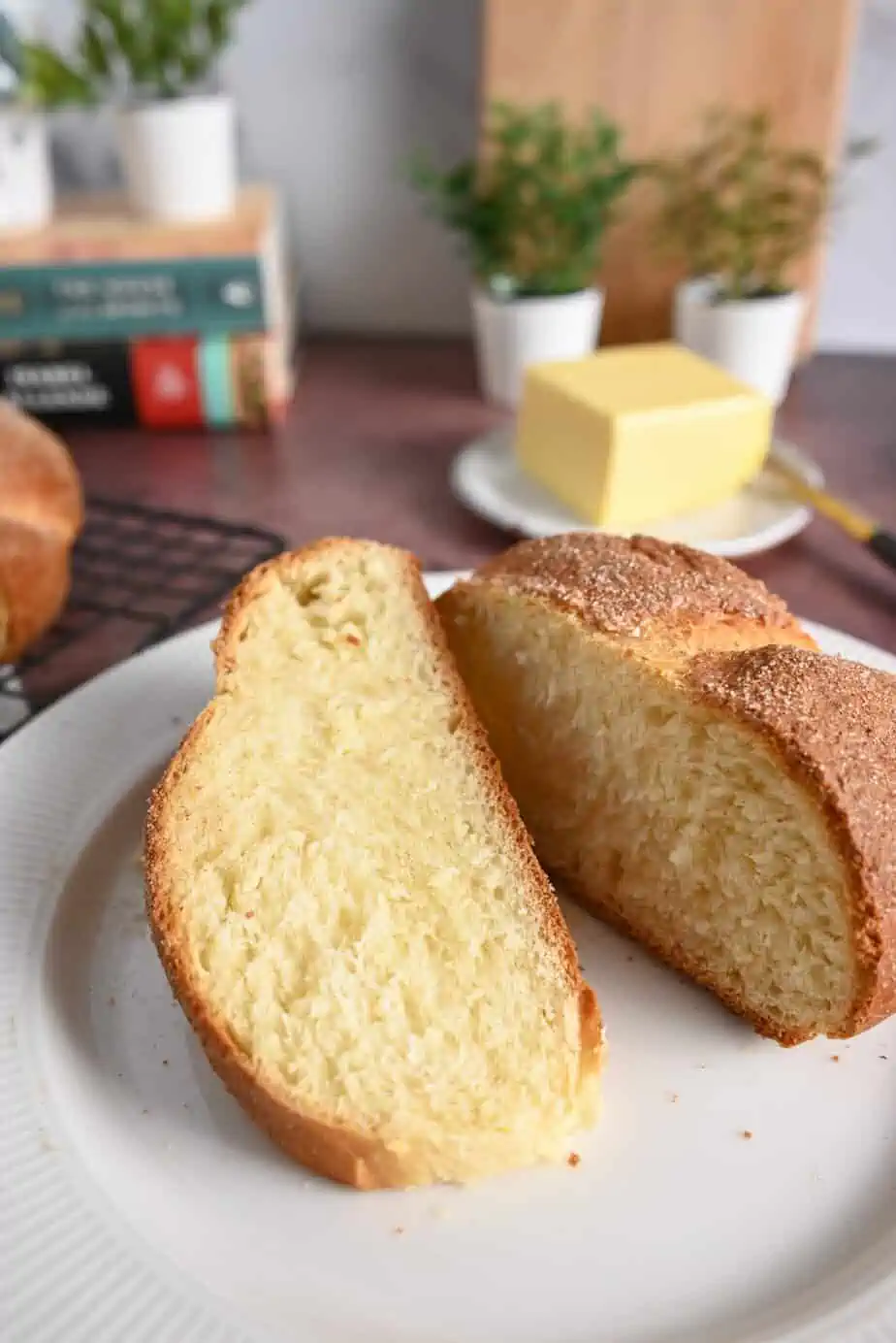 Two slices of pan de muerto on a white plate.