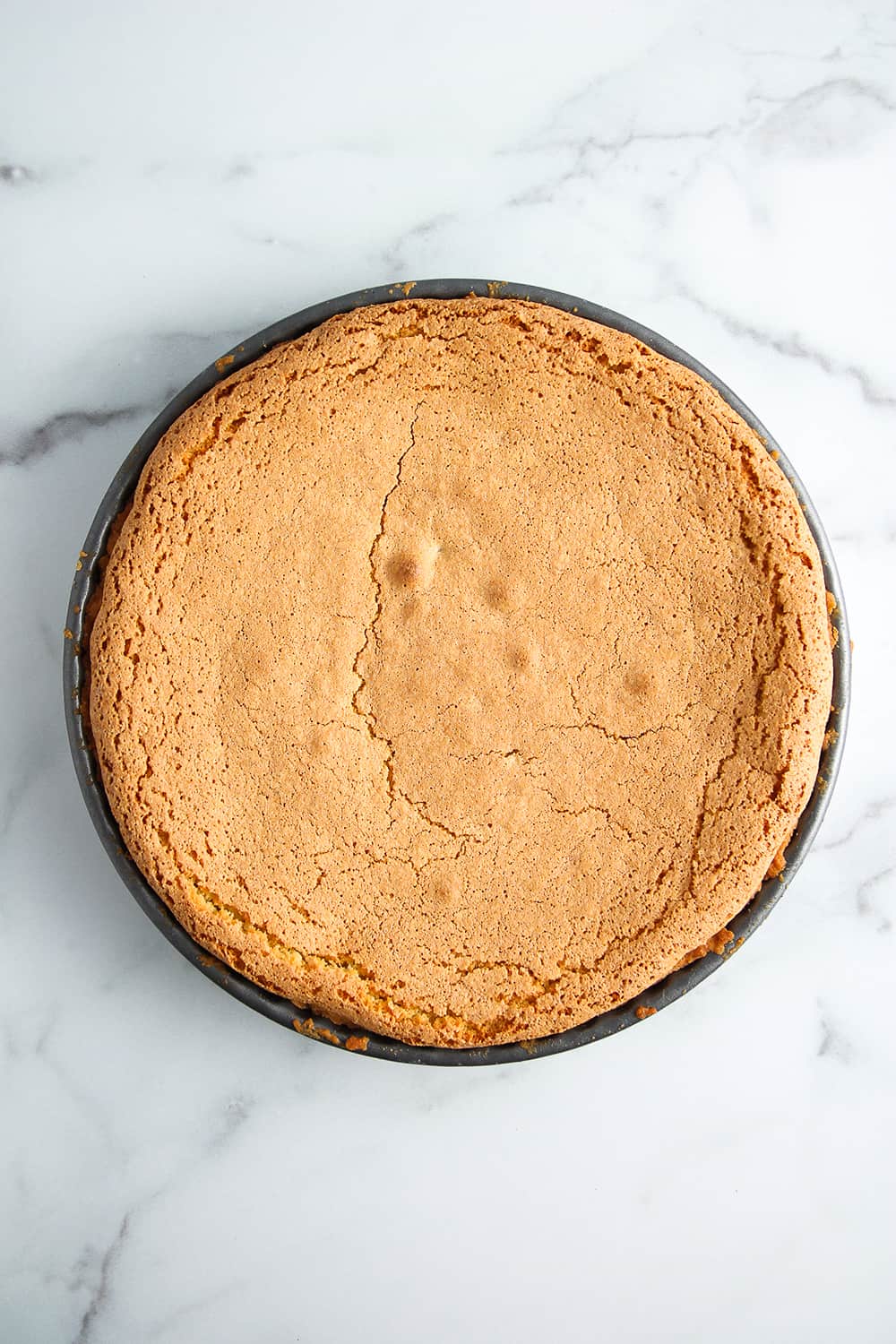 Baked tarta de santiago on a marble surface