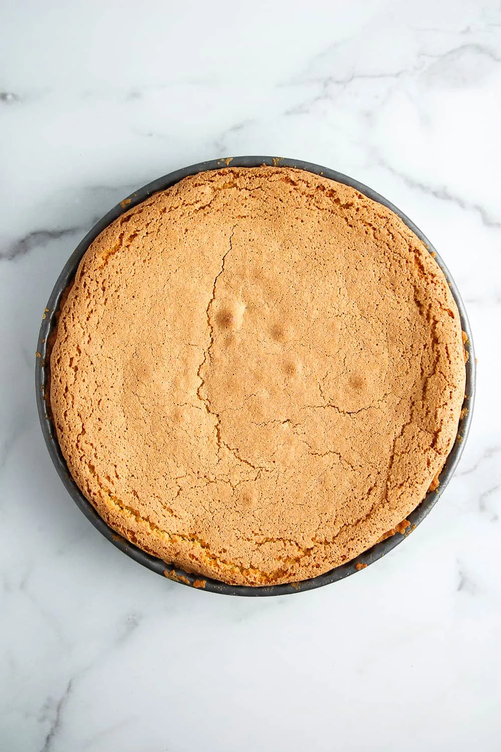 Baked tarta de santiago on a marble surface