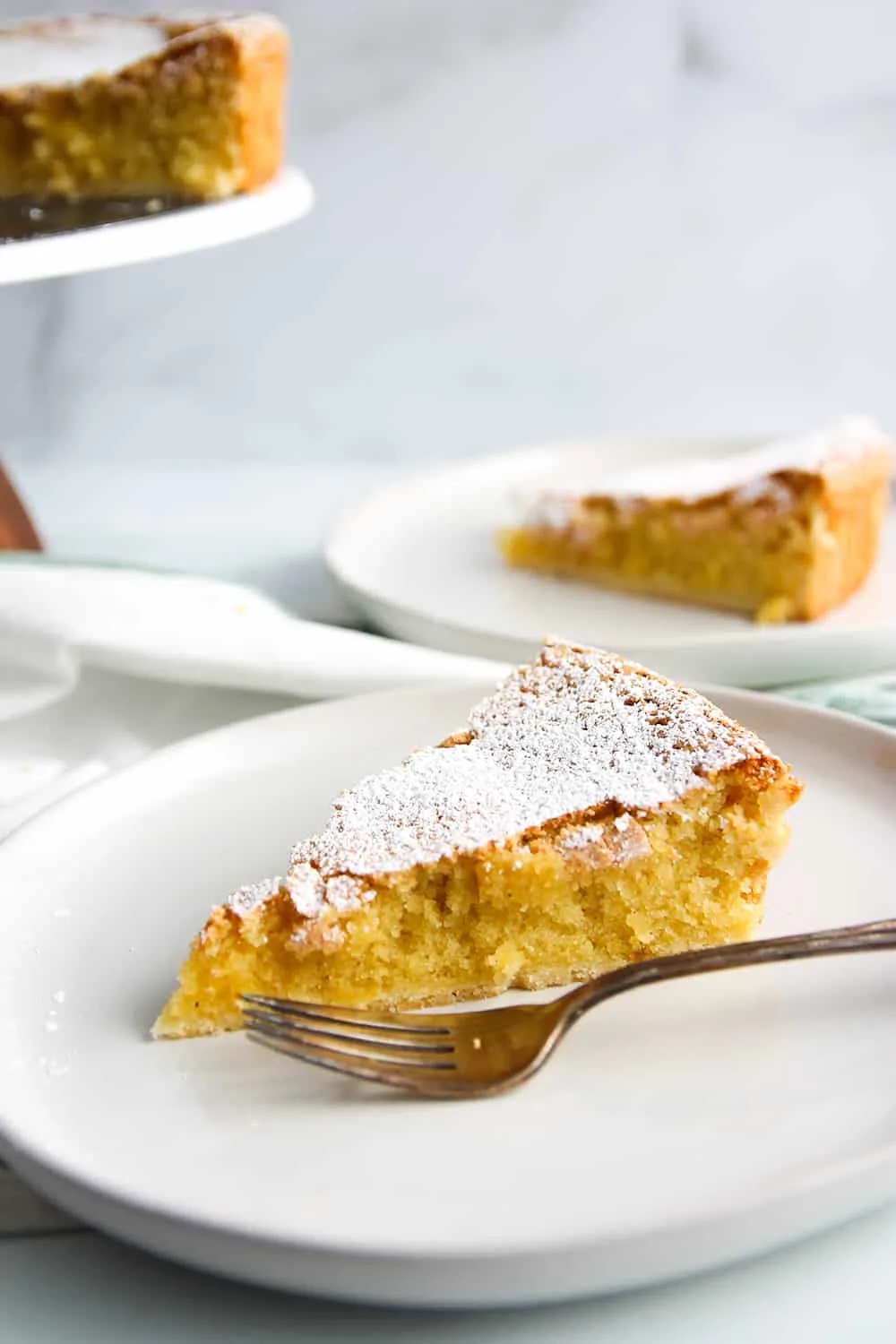 Slice of Tarta de Santiago on a white plate