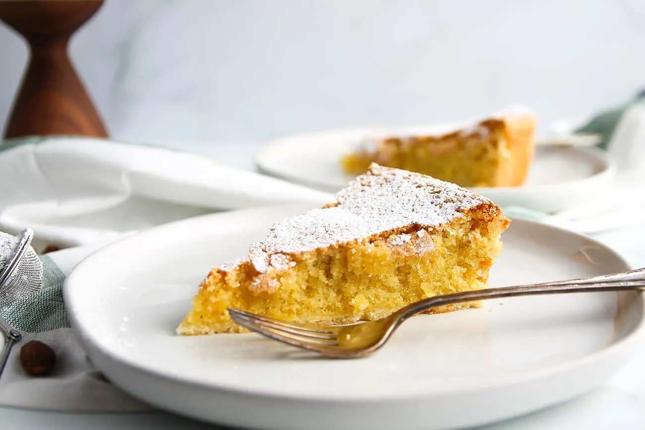 Slice of Galician Almond Tart dusted with powdered sugar