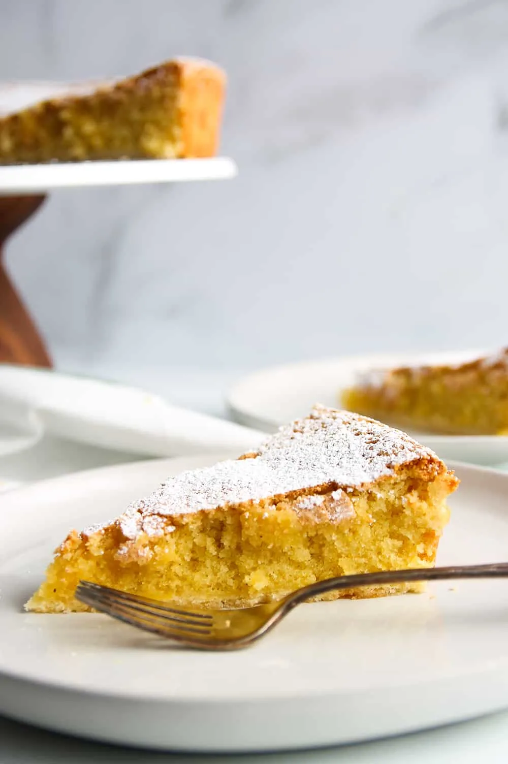 Plated Tarta de Santiago with a slice in the background