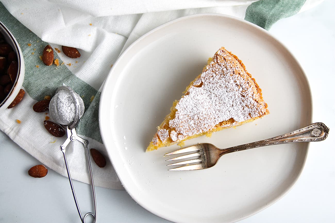 Slice of Tarta de Santiago dusted with powdered sugar