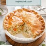 Homemade chicken pot pie with two slices taken from the pie plate. Text overlay includes recipe name.