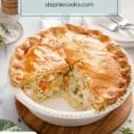 Homemade chicken pot pie with two slices taken from the pie plate. Text overlay includes recipe name.