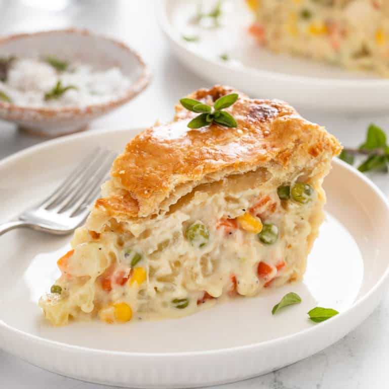 Slice of chicken pot pie on a white plate.