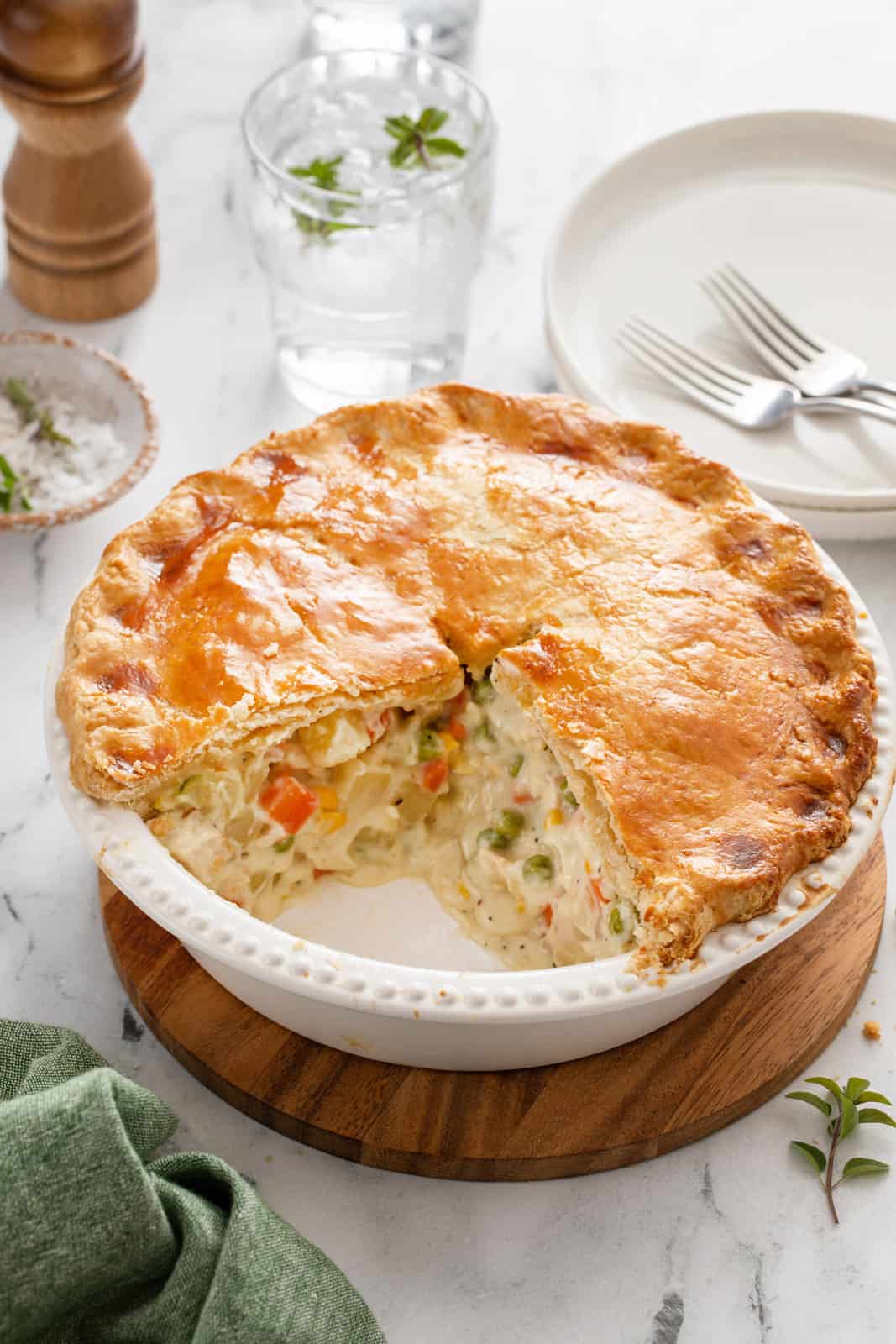 Homemade chicken pot pie with two slices taken from the pie plate.