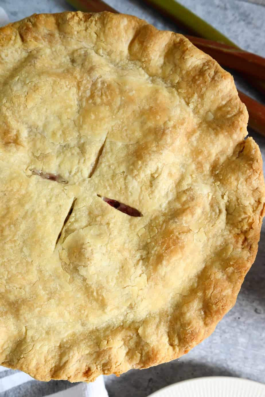 Close up view of the top crust for a baked rhubarb pie.
