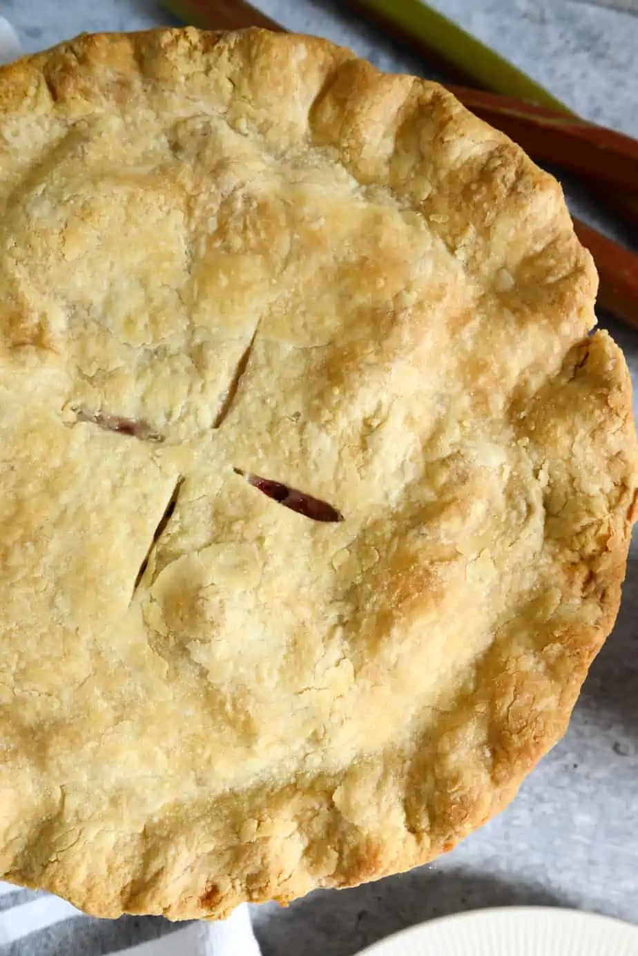 Close up view of the top crust for a baked rhubarb pie.