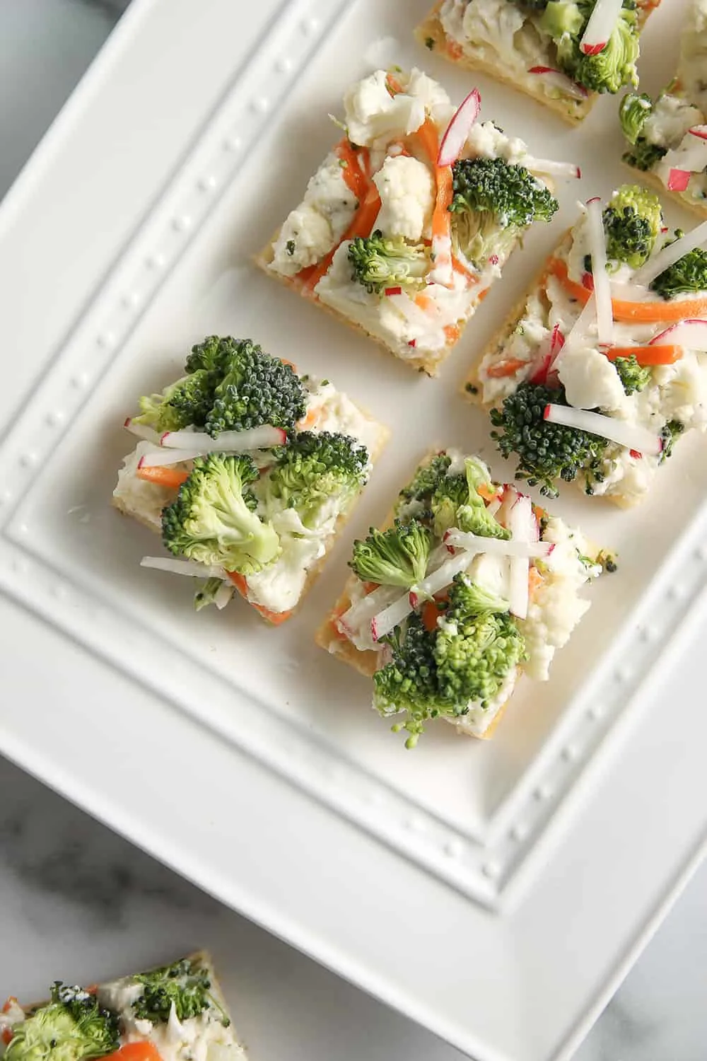 Vegetable Pizza is topped with ranch cream cheese and veggies for a great party appetizer