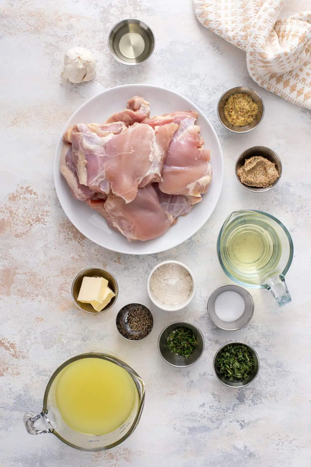Ingredients for easy garlic chicken arranged on a countertop.
