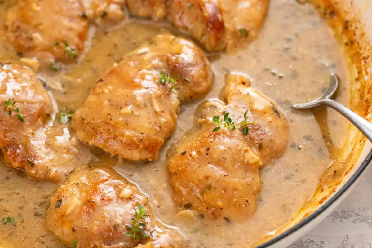 Easy garlic chicken thighs and sauce in a skillet.