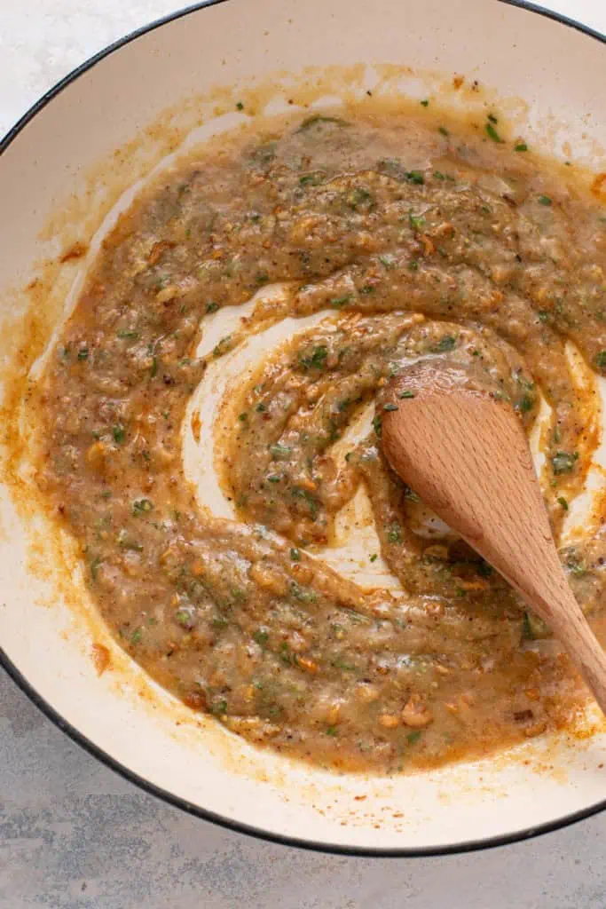 Wine and herbs added to a sauce base for garlic chicken.