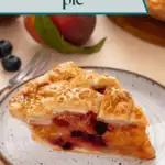 Slice of peach blueberry pie on a plate with the rest of the pie in the background. Text overlay includes recipe name.