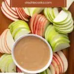 Overhead view of a bowl of apple dip surrounded by apple slices on a wooden board. Text overlay includes recipe name.