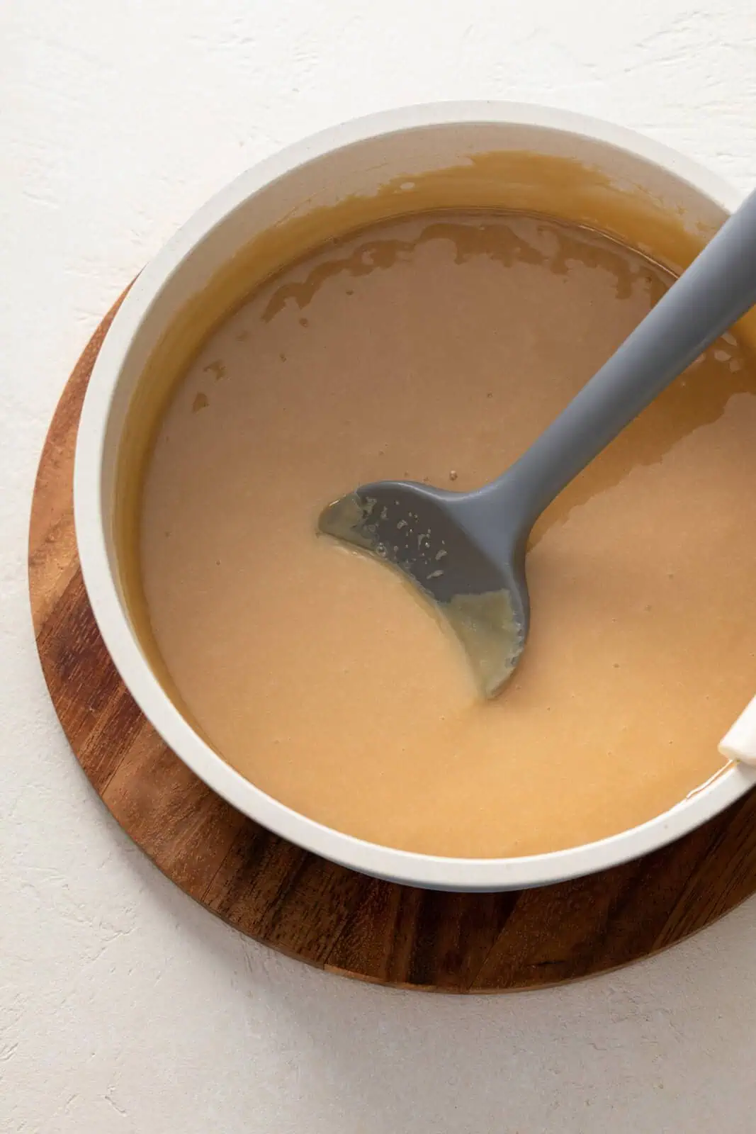 Cooked apple dip being stirred in a saucepan.