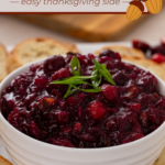 White bowl filled with cranberry chutney on a wooden board. Text overlay includes recipe name.