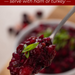 Spoon holding up a bite of cranberry chutney. Text overlay includes recipe name.