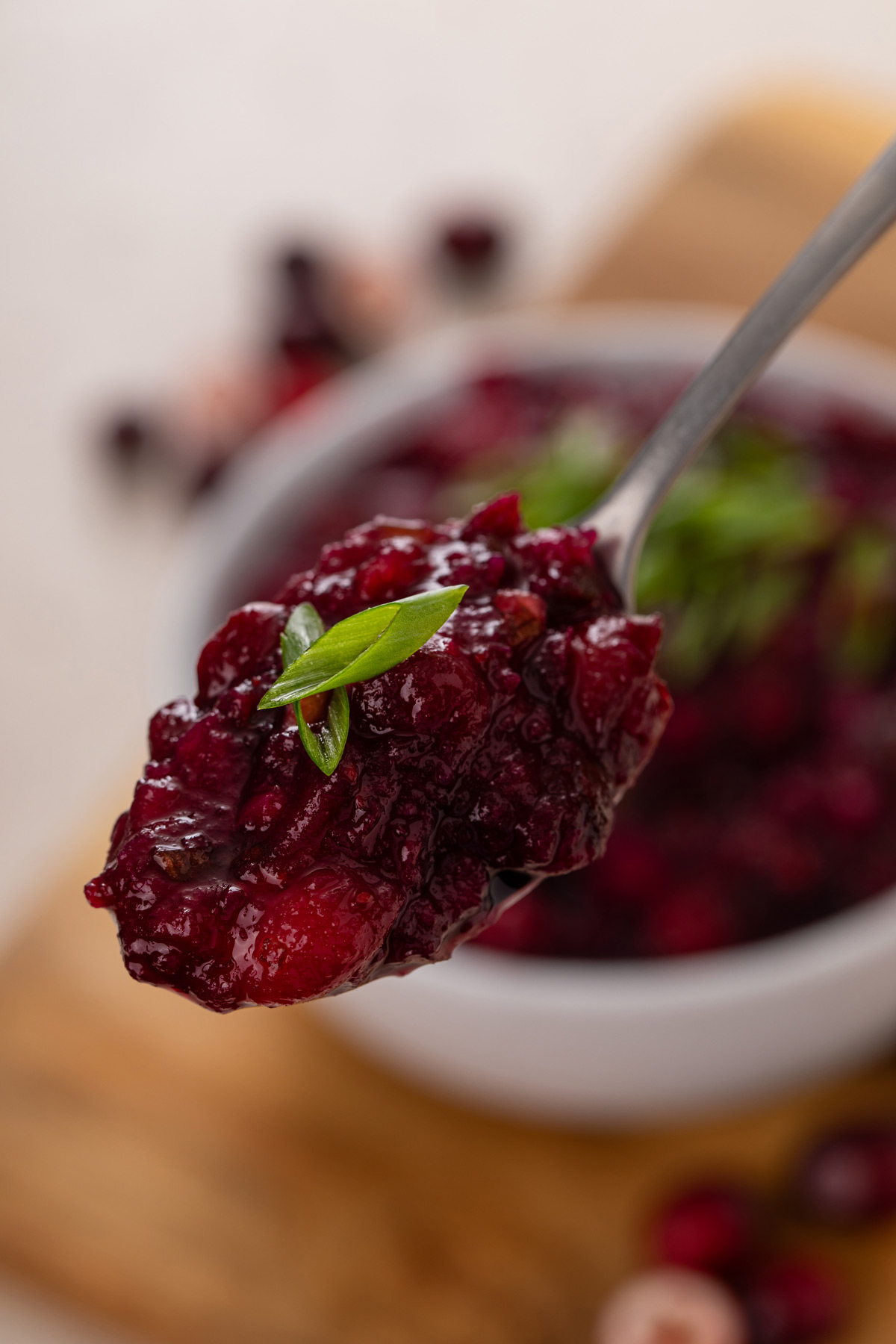 Spoon holding up a bite of cranberry chutney.