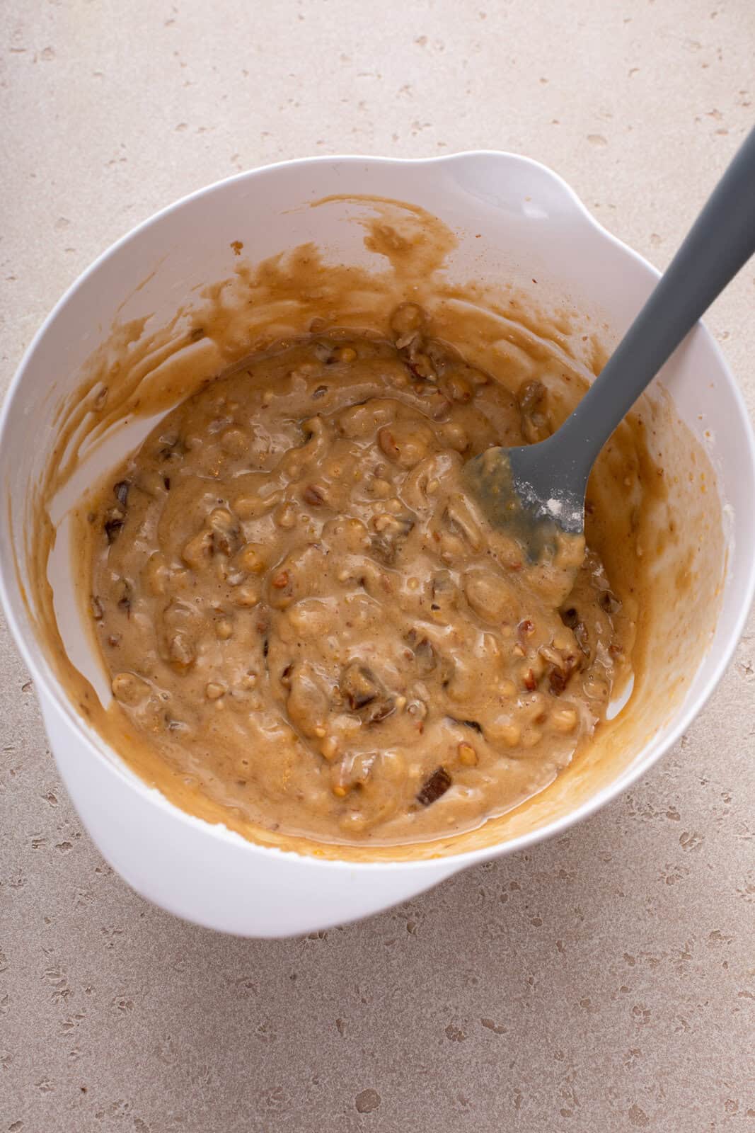 Batter base for date nut bread in a white bowl.