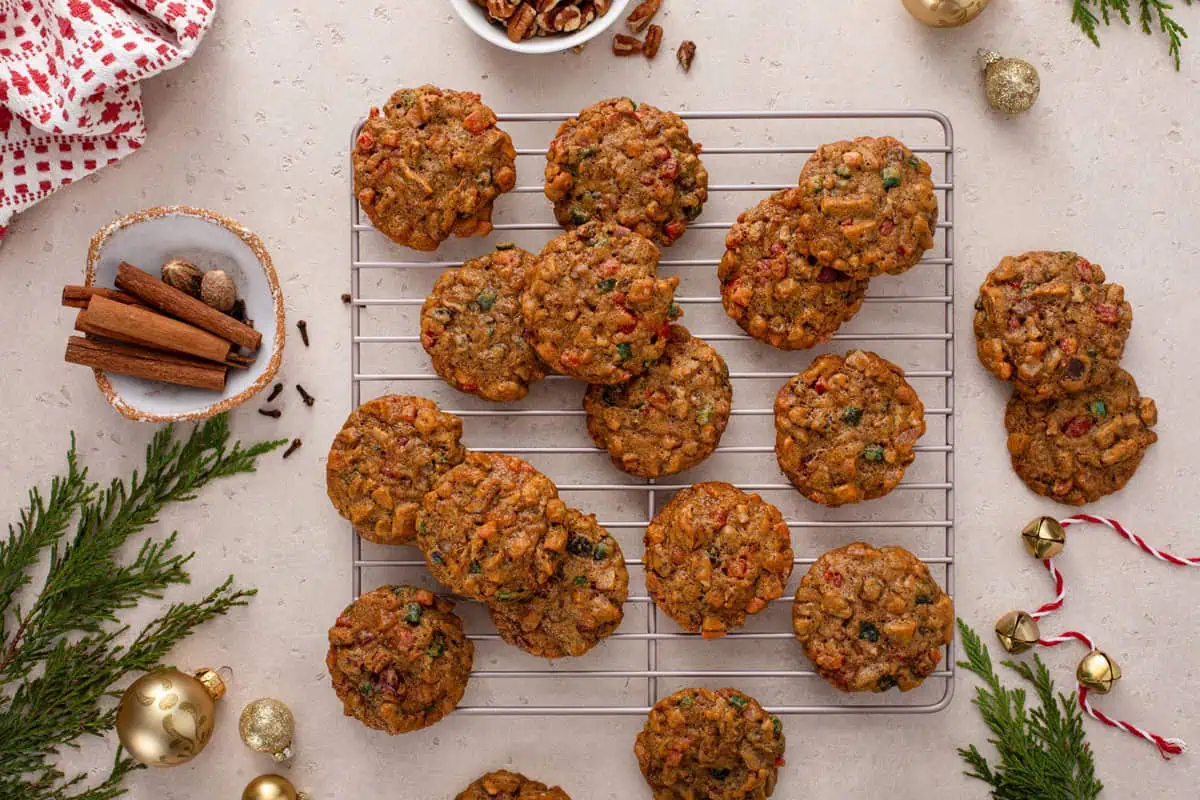 Baked fruitcake cookies arranged on a wire cooling rack.