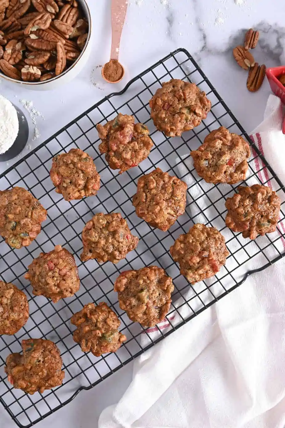 Fruitcake cookies cooling on a metal cooling rack.