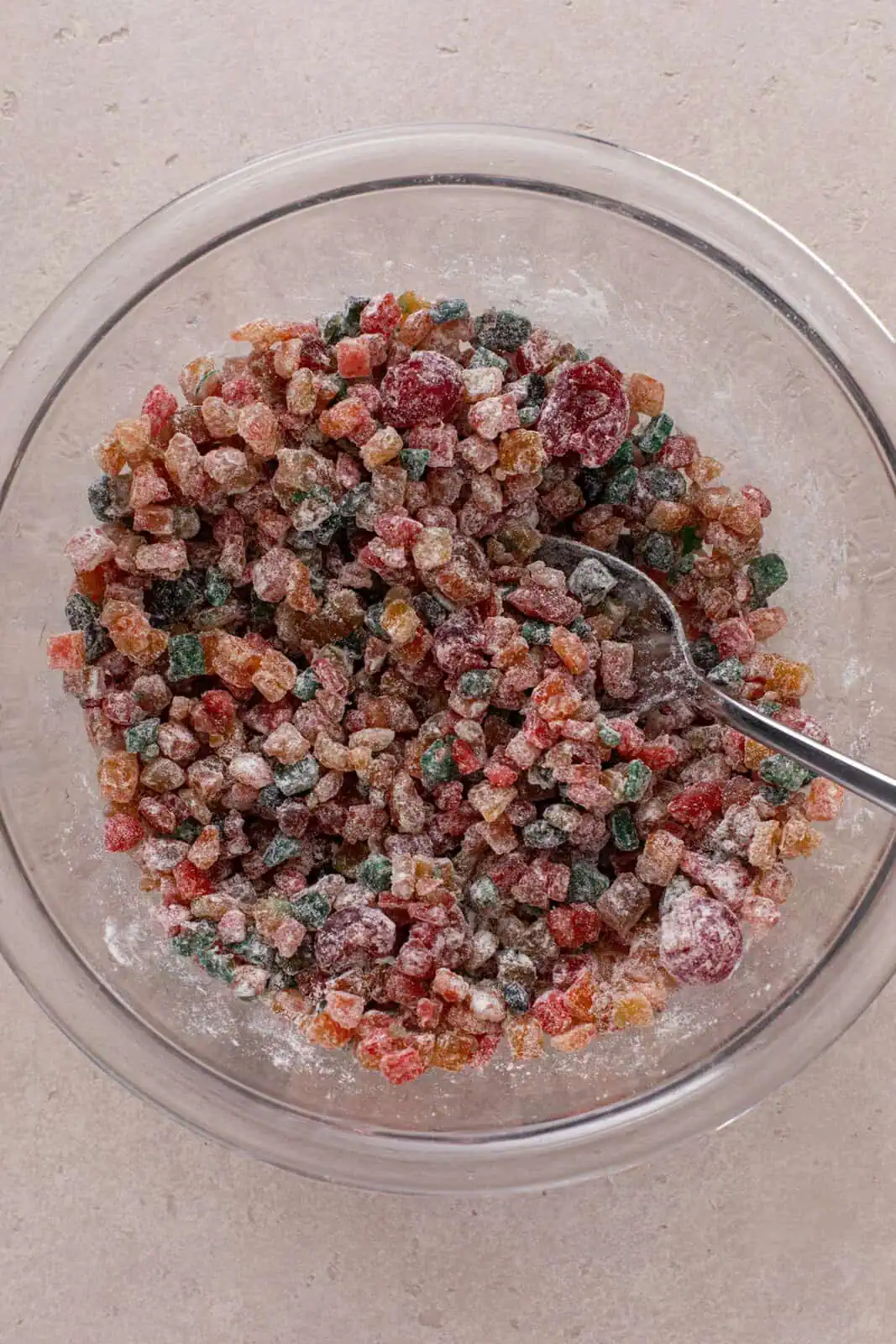 Chopped candied fruit mixed with a few tablespoons of flour in a bowl.