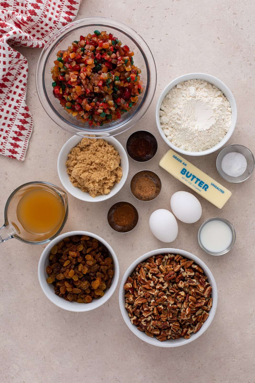 Fruitcake cookie ingredients arranged on a countertop.