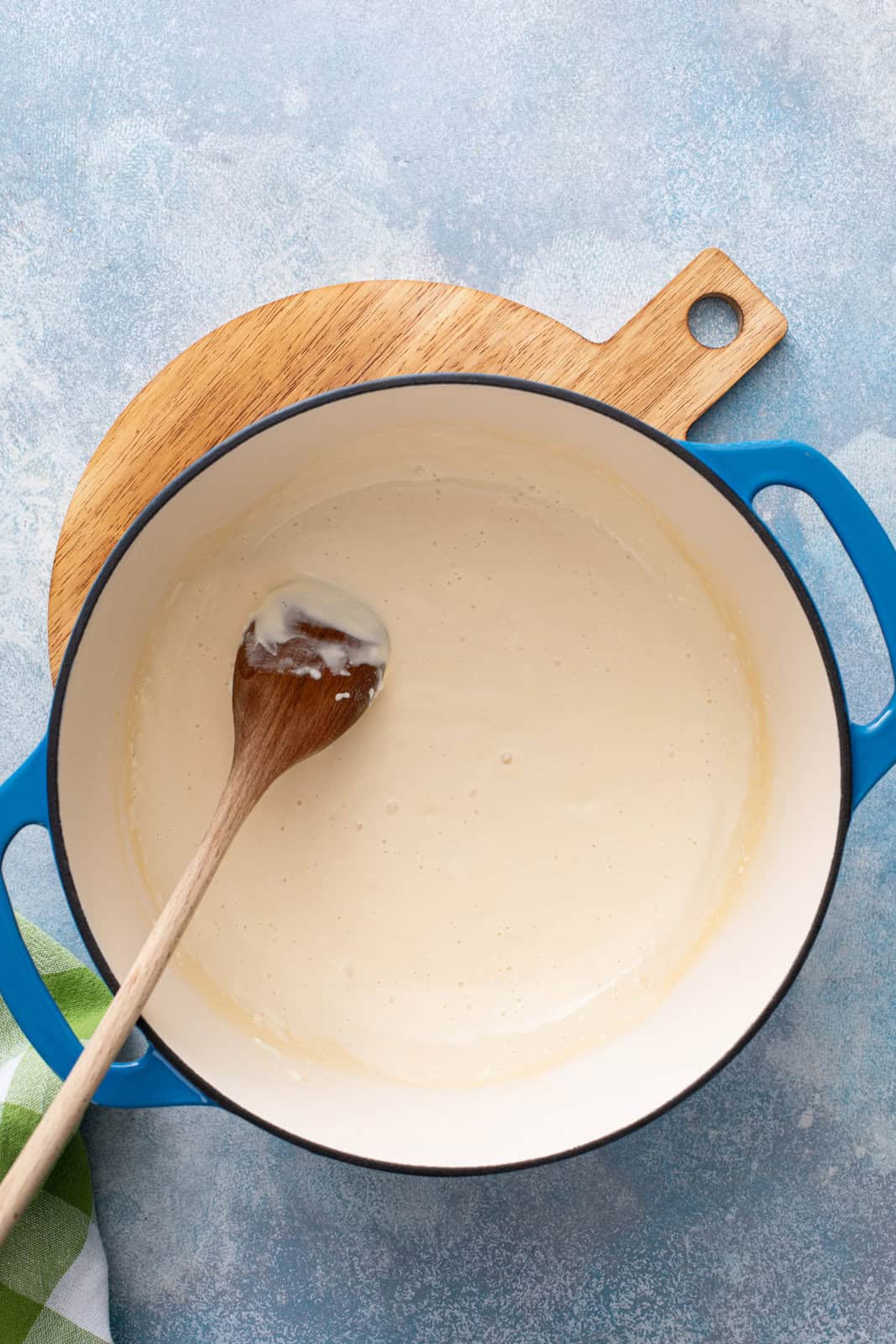 Cheese sauce base for homemade shells and cheese in a dutch oven.