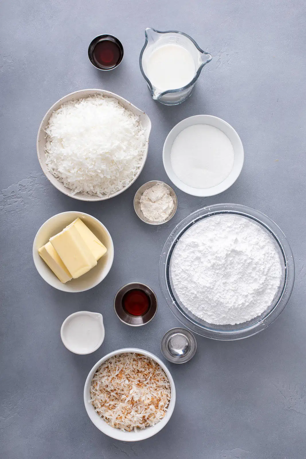 Ingredients for coconut filling and coconut frosting arranged on a gray countertop.