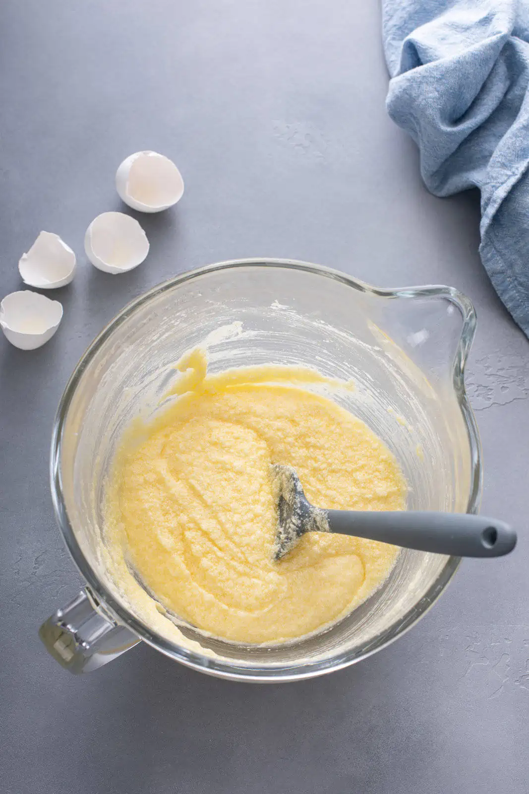 Wet ingredients for coconut cake batter in a stand mixer.