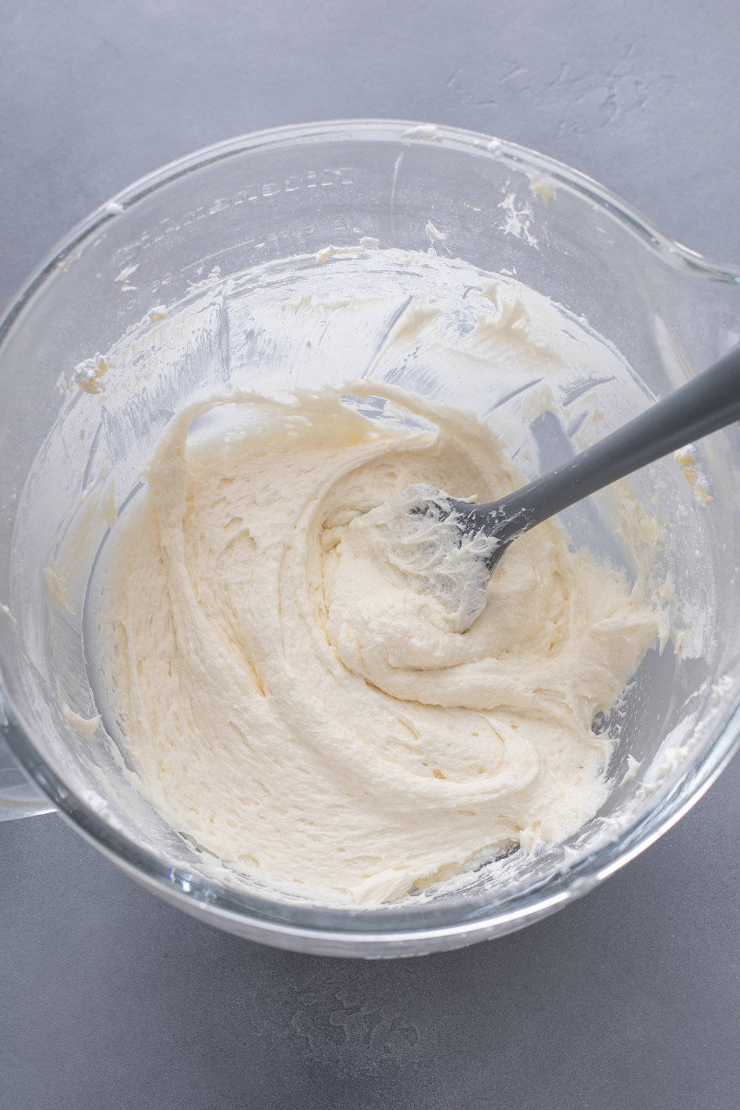 Coconut frosting in a white mixing bowl.