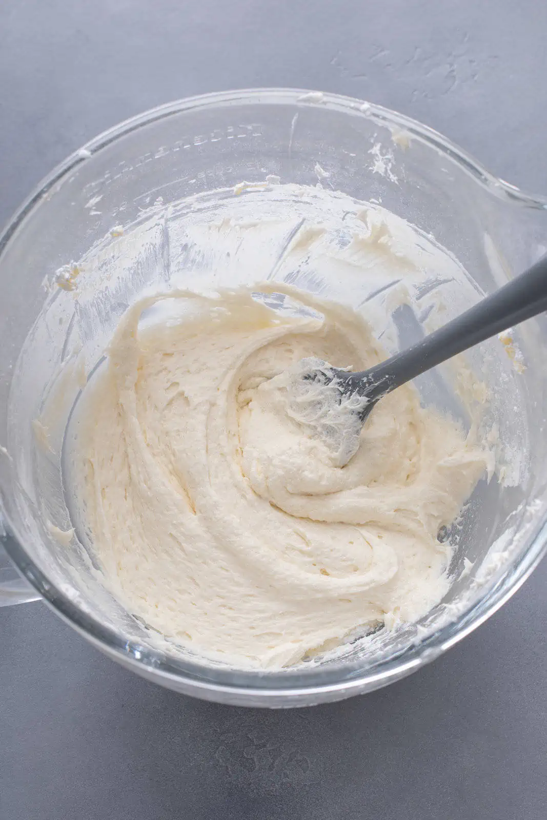 Coconut frosting in a white mixing bowl.