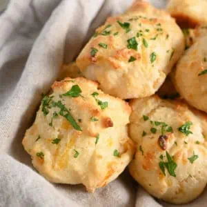 Close up of homemade Red Lobster biscuits in a linen-lined basket.