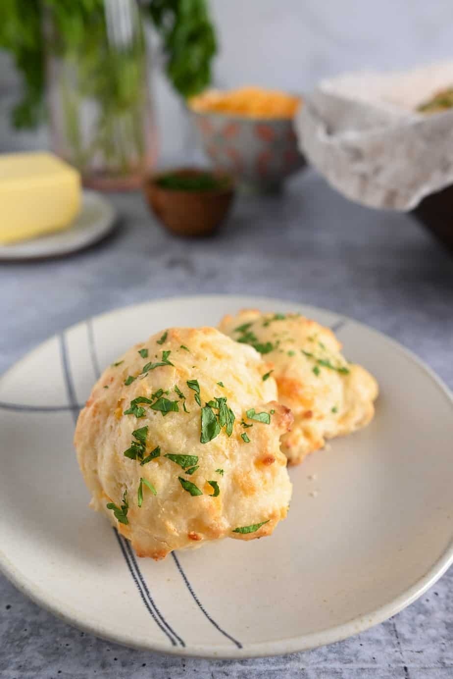 Two homemade red lobster biscuits on a blue and white plate.