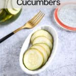 Close up of pickled cucumbers in a white dish on a concrete countertop. Text overlay includes recipe name.