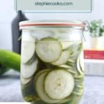 Glass jar filled with pickled cucumbers. Text overlay includes recipe name.