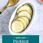 Overhead view of a white oval dish filled with pickled cucumbers. Text overlay includes recipe name.