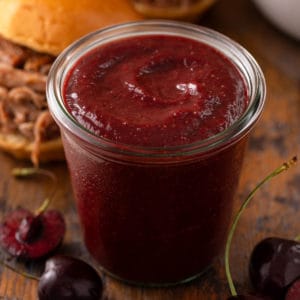 Roasted cherry barbecue sauce in a glass jar.