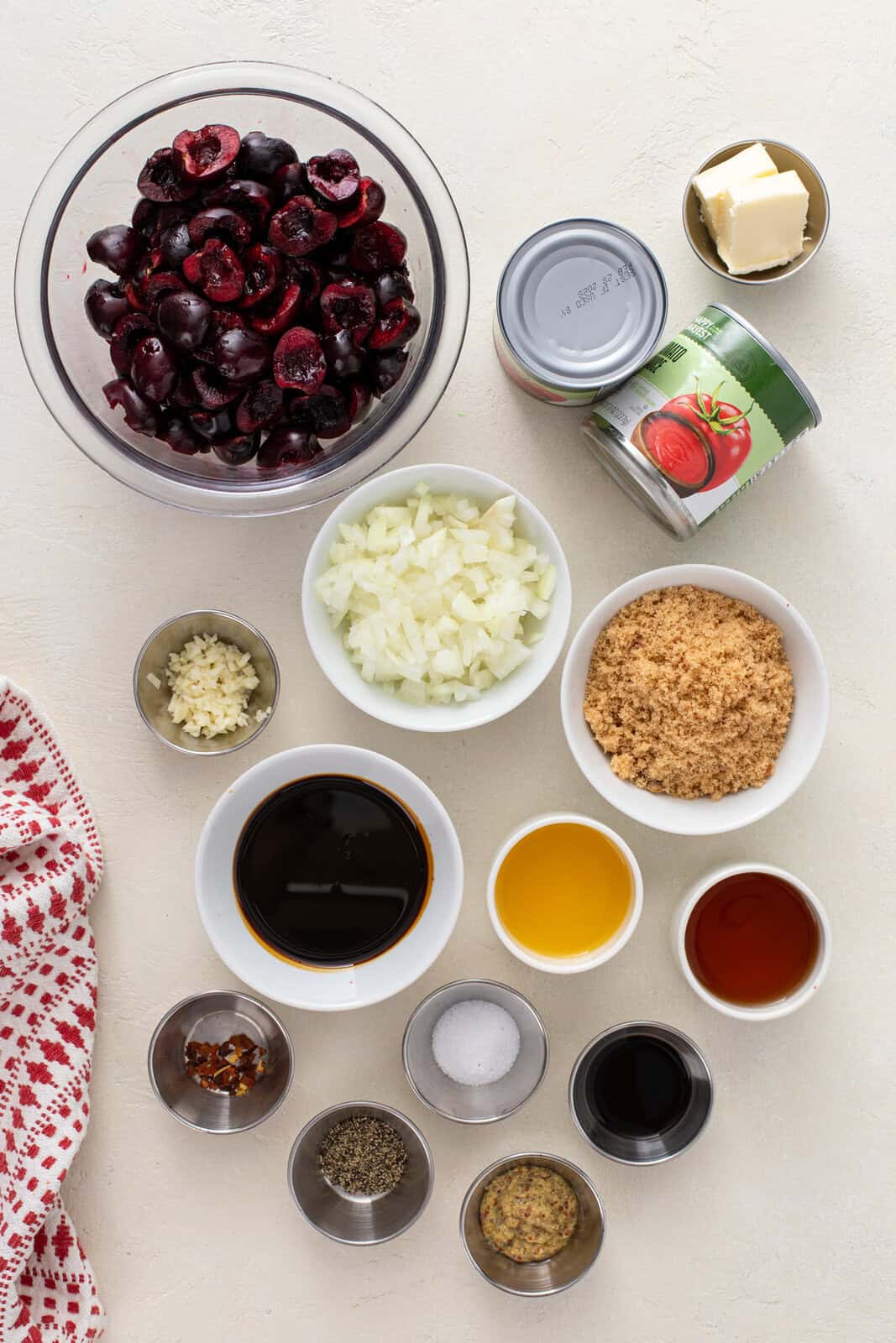 Ingredients for cherry barbecue sauce arranged on a countertop.