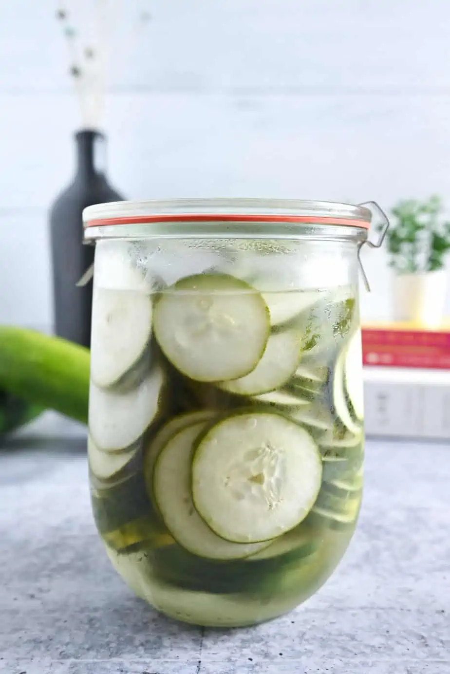 Glass jar filled with pickled cucumbers.