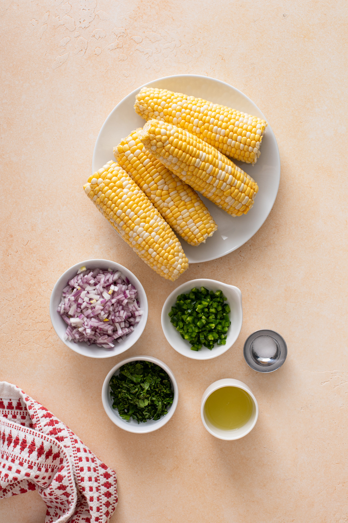 Roasted corn salsa ingredients arranged on a countertop.