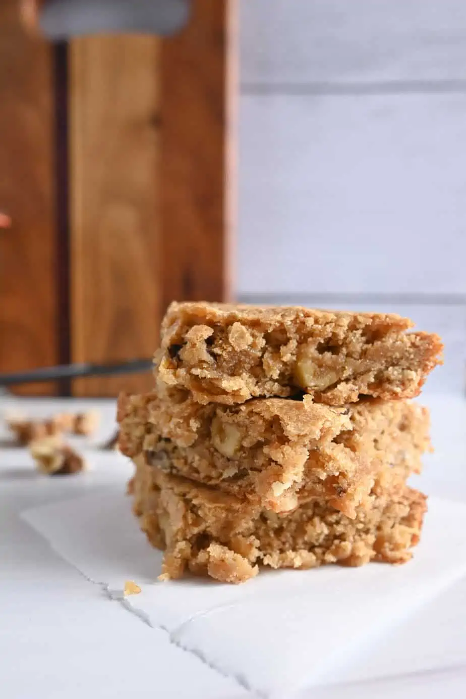 Stacked maple walnut blondies on a kitchen countertop.