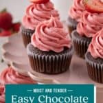 Close up of easy chocolate cupcakes topped with strawberry frosting on a pink cake stand. Text overlay includes recipe name.