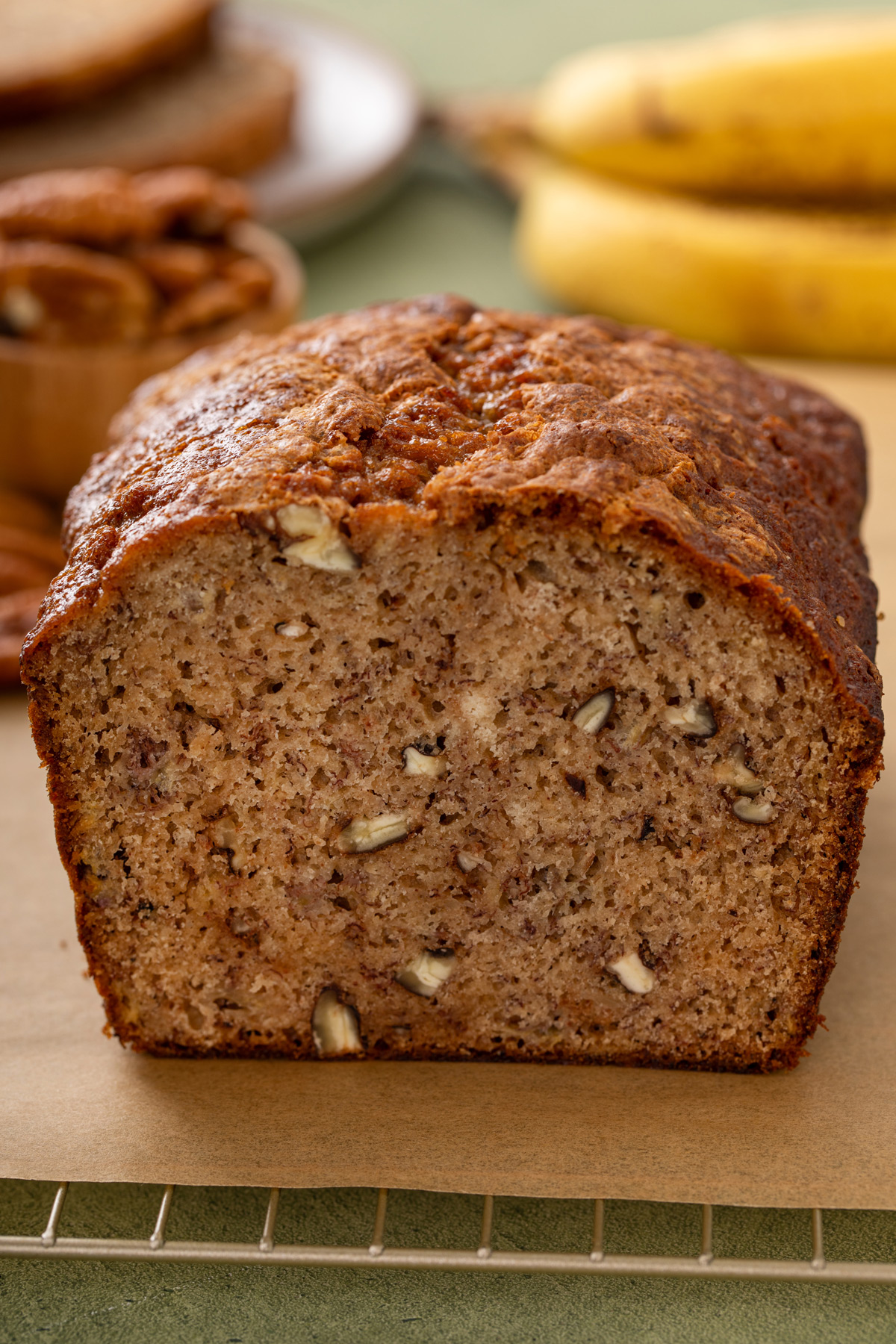 Loaf of banana bread that's been sliced in half to show the moist, dense crumb.