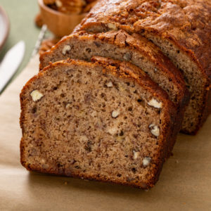 Slices of bisquick banana bread on a wooden cutting board.