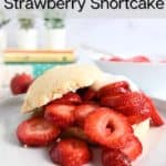 White plate with strawberry shortcake topped with whipped cream and sliced strawberries. Text overlay includes recipe name.