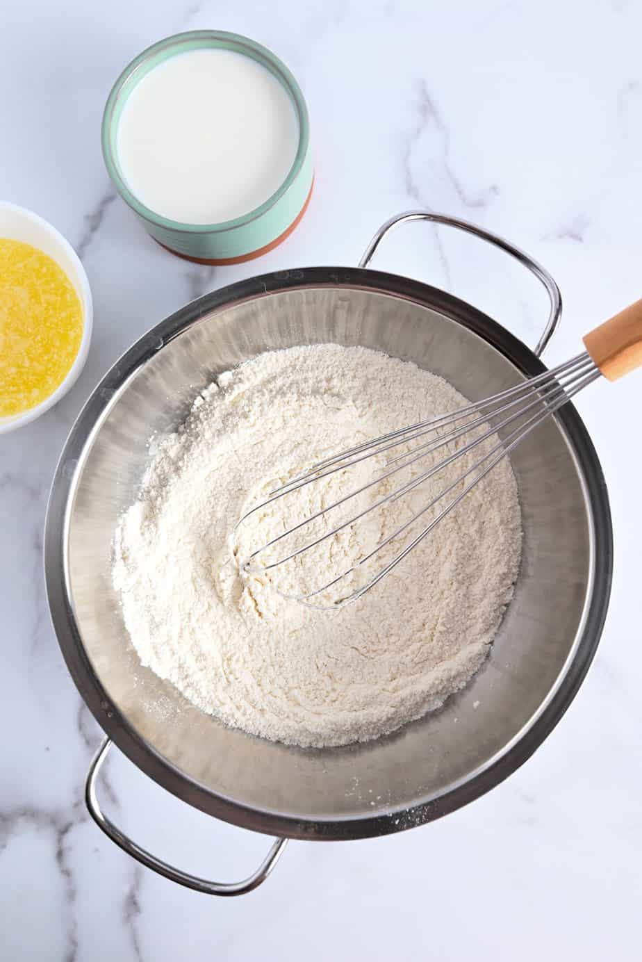 Dry ingredients for shortcakes being whisked in a metal bowl.