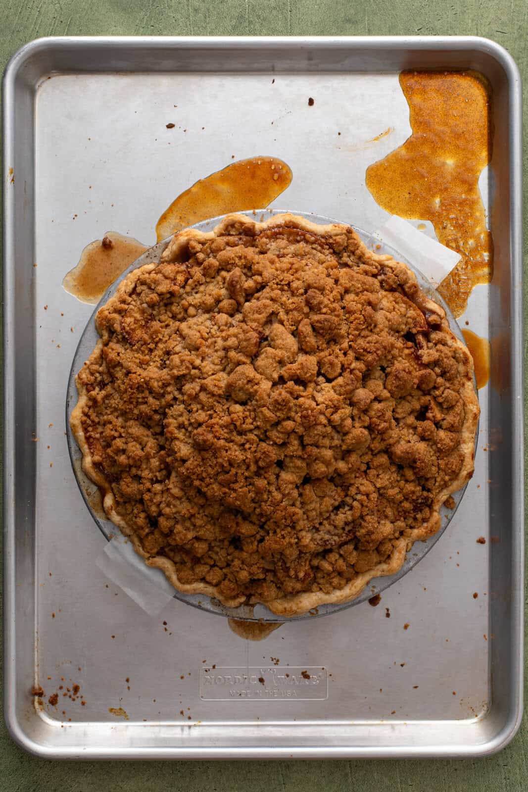 Baked dutch apple pie on a rimmed baking sheet.
